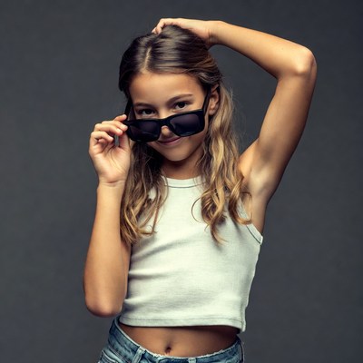 Girl holding sunglasses smiling