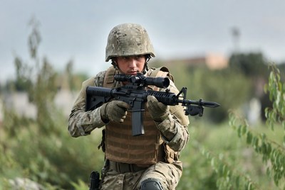 Soldier aiming M4 rifle outdoors