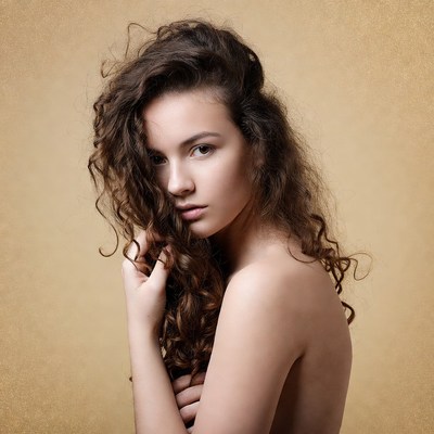 Curly-haired woman with bare shoulders