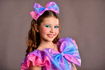 Girl in pink iridescent costume with bow