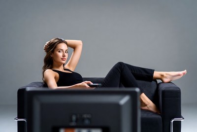 Woman lounging on couch with remote