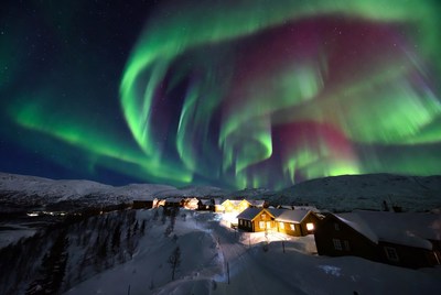 Aurora Borealis over Snowy Village