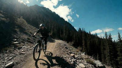 Man mountain biking on trail