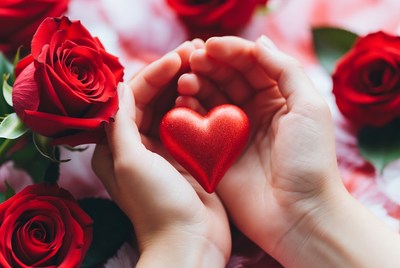 Hands Holding Red Heart with Roses