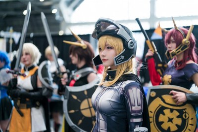 Group of women in cosplay armor with swords
