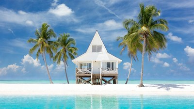 White bungalow on tropical sandbar