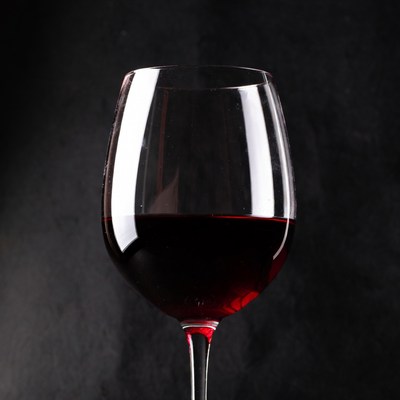 Red wine glass on black background