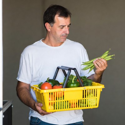 Man holding basket of vegetables