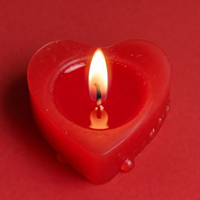 Red Heart-Shaped Candle Burning
