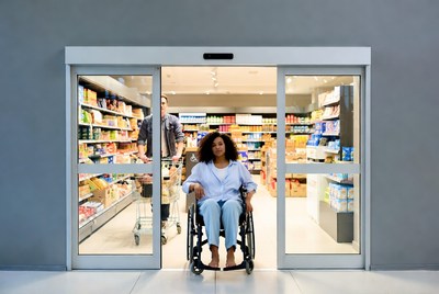 African-American woman in wheelchair at store entrance