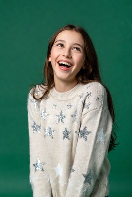 Girl smiling in sparkly star sweater