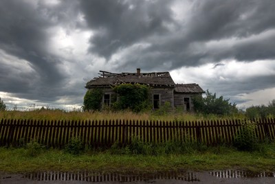 Abandoned house under stormy sky