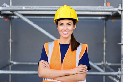 Woman in yellow hard hat and vest