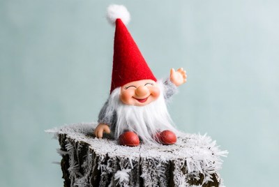 Smiling Christmas Gnome on Snowy Stump