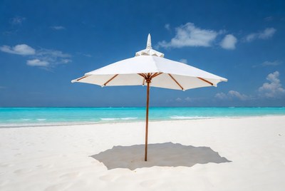 White beach umbrella on sandy shore