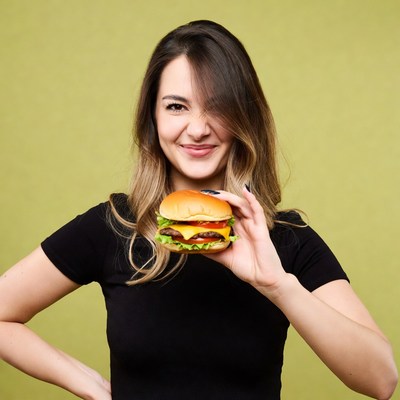 Woman holding juicy double burger