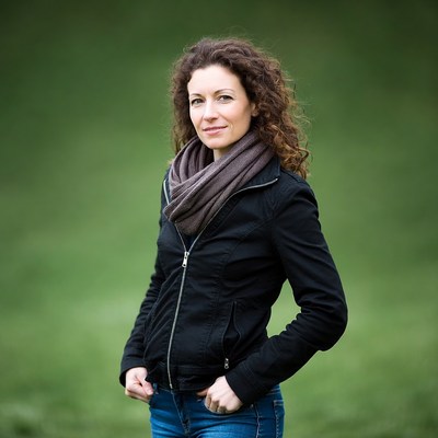 Woman with curly hair in black jacket