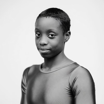African girl in shiny black leotard