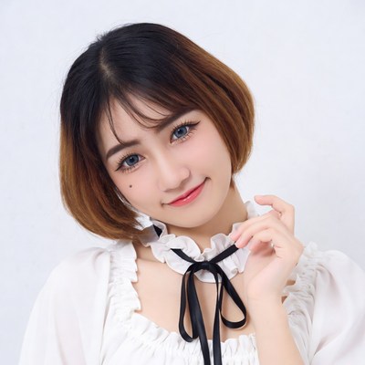 Asian woman in ruffled blouse smiling