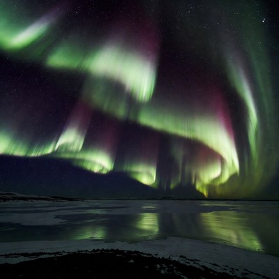 Vibrant Northern Lights over Frozen Lake