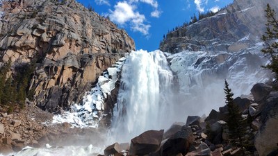 Majestic waterfall cascading snowy mountains