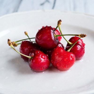 Fresh Red Cherries on White Plate