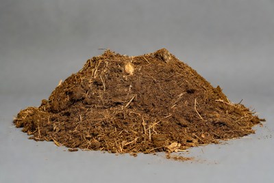 Pile of brown dirt on gray background