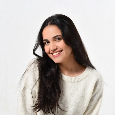 Smiling young woman in white sweater