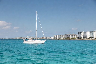 White Sailboat on Turquoise Water with Skyscrapers