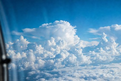 Aerial View of Fluffy Clouds from Airplane