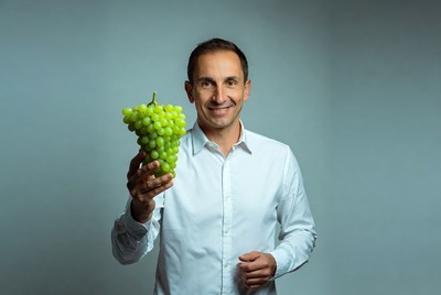 Man holding green grapes