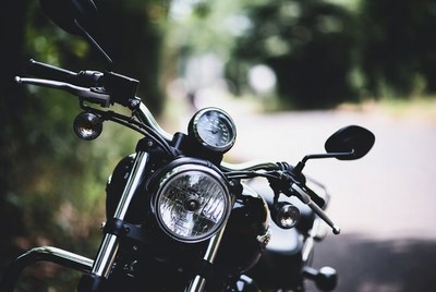 Black Motorcycle Parked on Forest Road