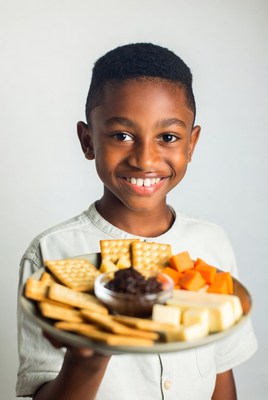 African-American boy holding snack platter
