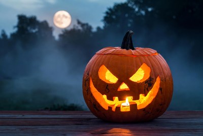 Lit Jack-o'-lantern with moon and fog