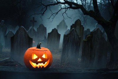 Jack-o'-lantern in foggy graveyard