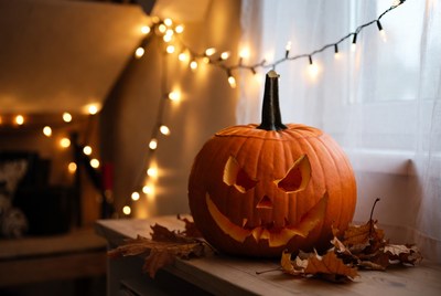 Jack-o'-lantern on windowsill with lights