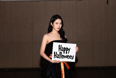 Asian woman holding Happy Halloween sign