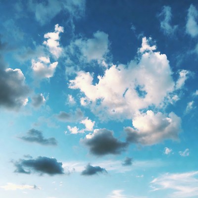 Fluffy white clouds in blue sky