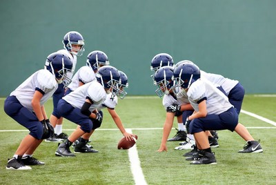 Youth football team in huddle