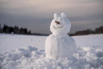 Snowman in snowy field
