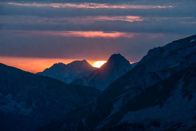 Sunset Behind Snowy Mountains