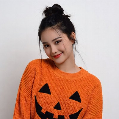 Asian woman in jack-o-lantern sweater