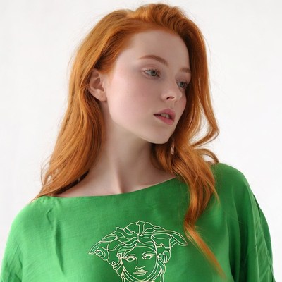 Redhead woman in green Versace shirt