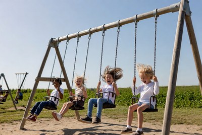 Girls swinging on playground swings