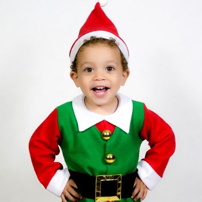 Toddler boy in elf costume smiling
