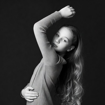 Teen girl posing with raised arm