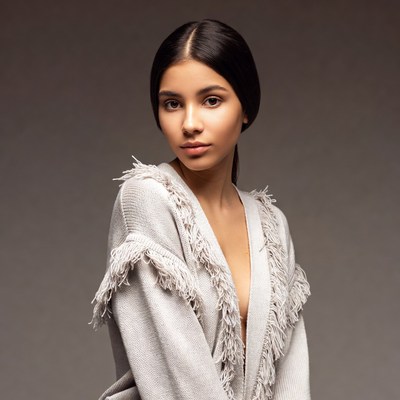 Young woman in fringed sweater