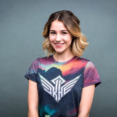 Smiling woman in colorful SKHE t-shirt