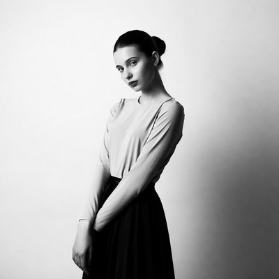 Woman in black skirt gray top