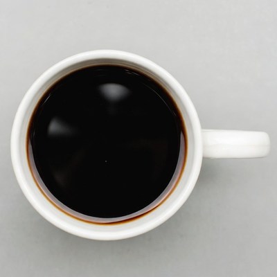 Top view of coffee in white mug
